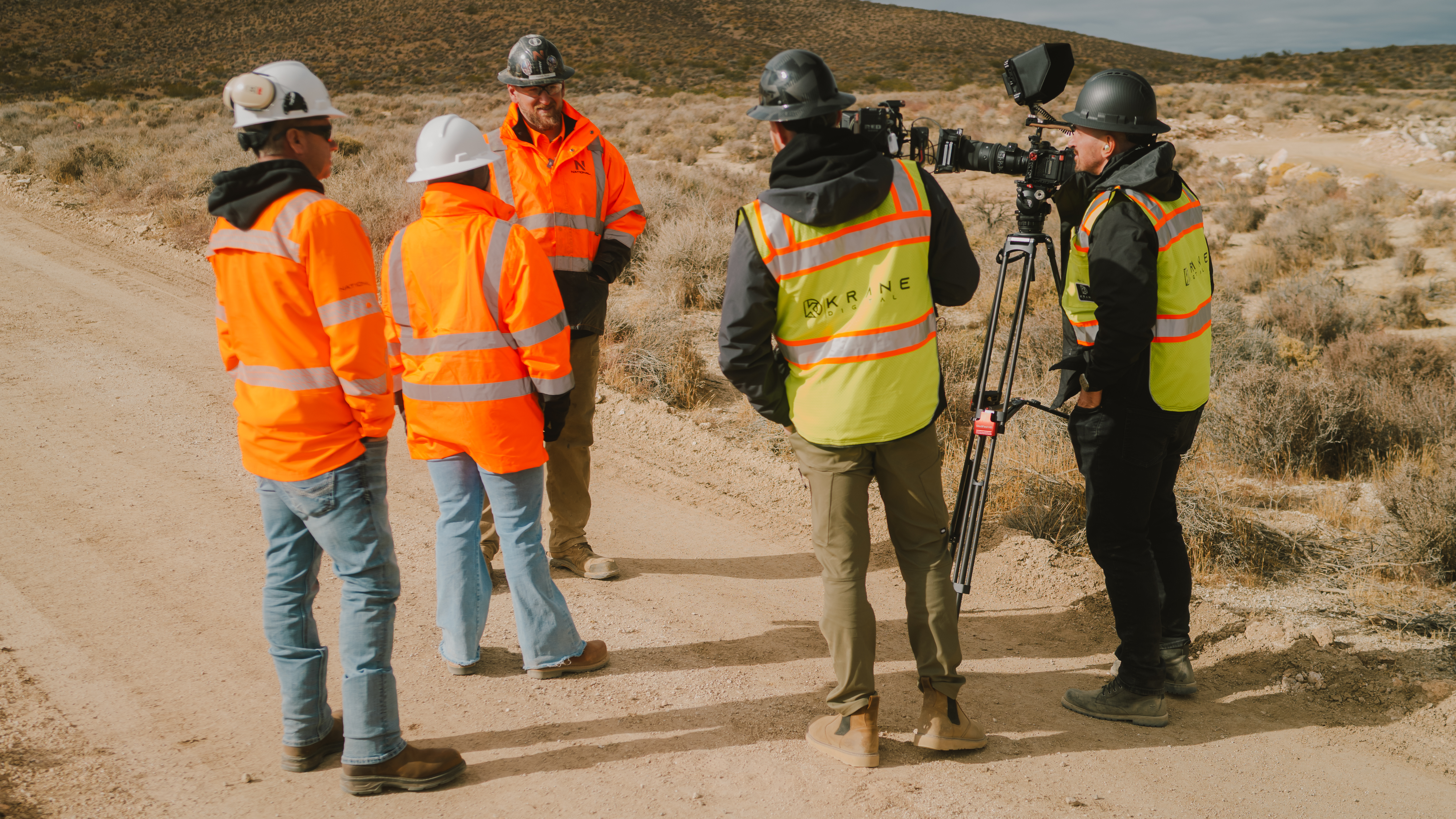 Krane Digital crew filming on a construction site with camera and tripod