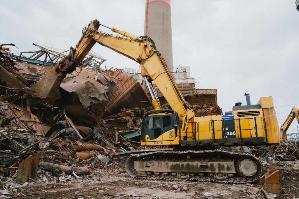 Yellow Komatsu excavator on demolition site