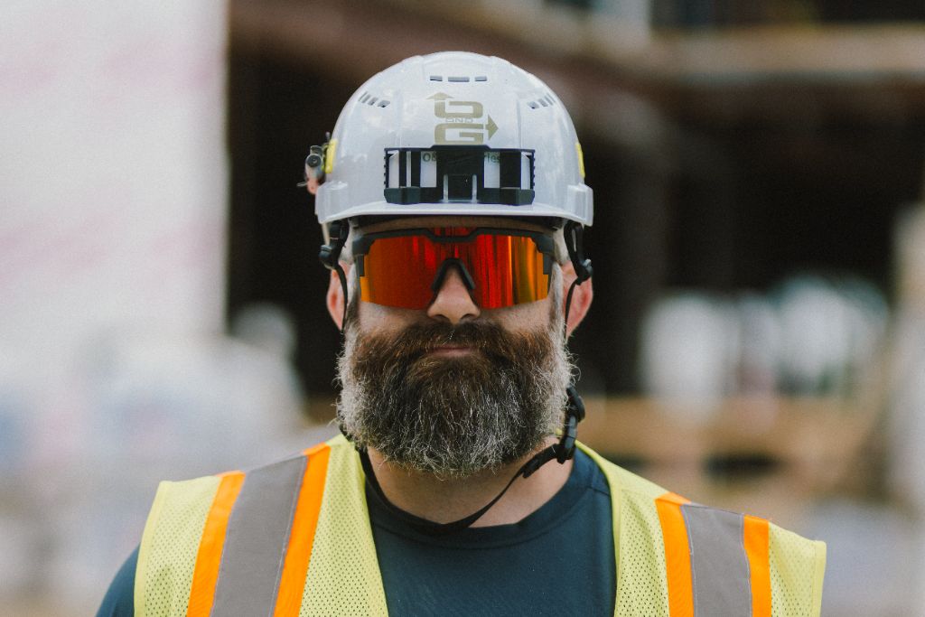 Construction worker in hard hat and high-vis vest on job site